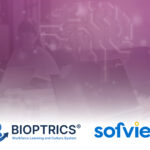 Team of colleagues collaborating around a table with laptops; purple digital background and circuit graphics, with Bioptrics and Sofvie branding at the bottom.